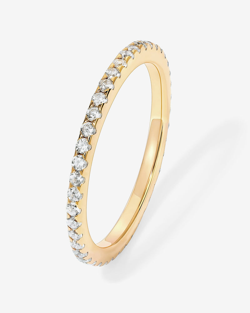 Close-up of Mila Eternity Band showcasing a gold-tone band with clear stones on a white background